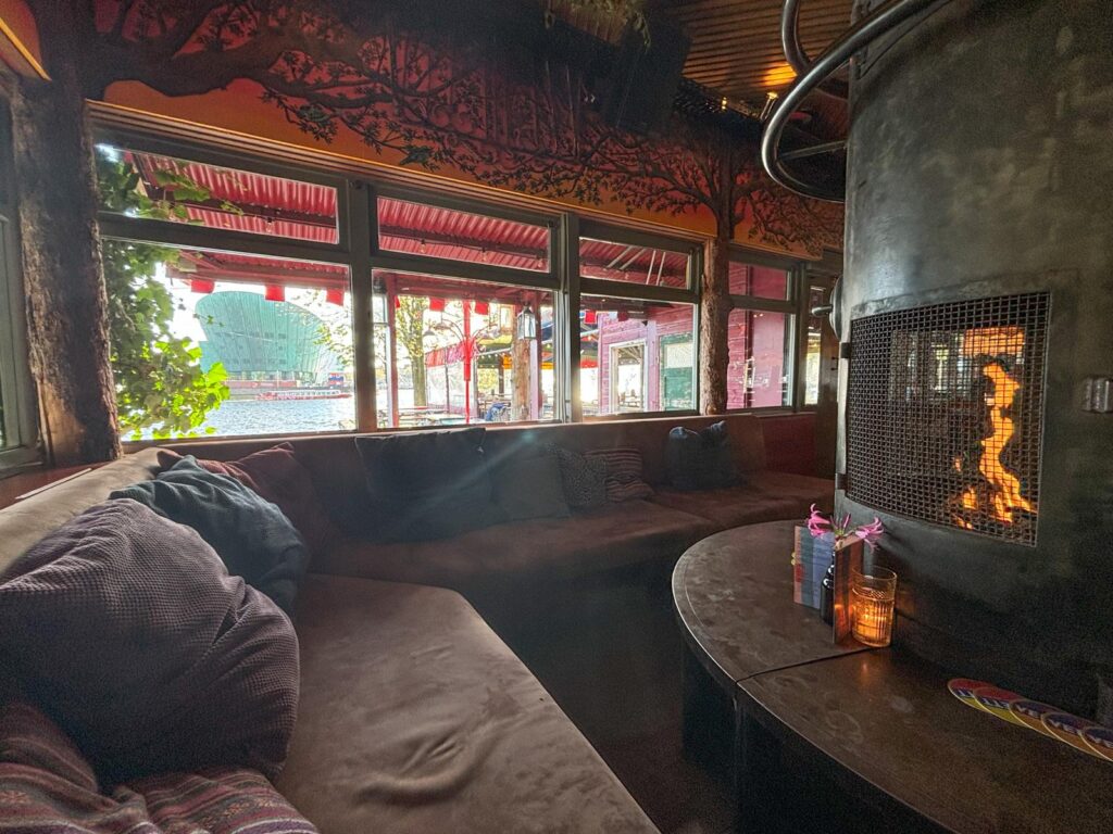 Comfortable seating inside Hannekes Boom cafe with the winter fire giong