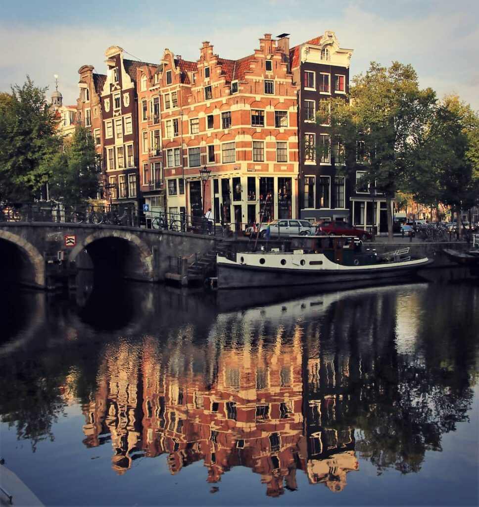 One of Amsterdam's best views, Papeneiland photograped from across the canal with early morning reflection of the building on the water.