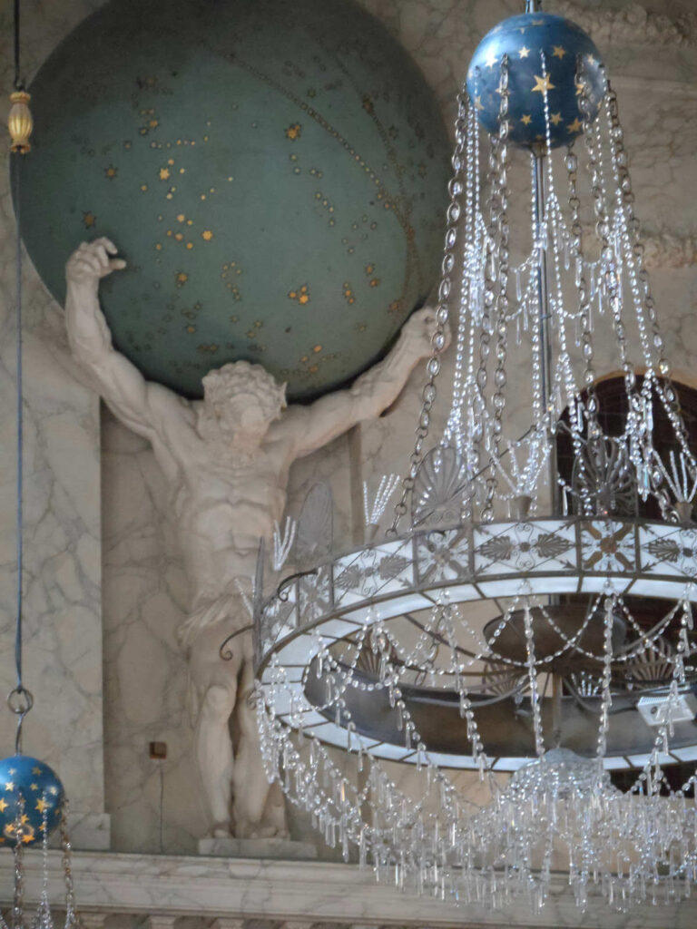 Interior dertail of Amsterdam's Royal Palace with Atlas holding the world on his shoulders and a beautiful chandelier