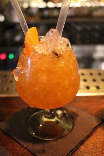 A coctail with lots of crushed ice and orange