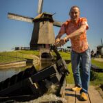 Mark pumping water on a Private Amsterdam Windmill Tour